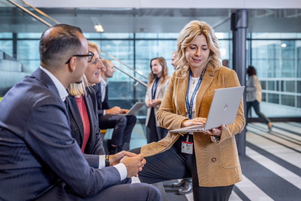 Groepje jonge collega's bij BZ in gesprek op de trap. Zij volgen het werk- en leertraject IBBZ